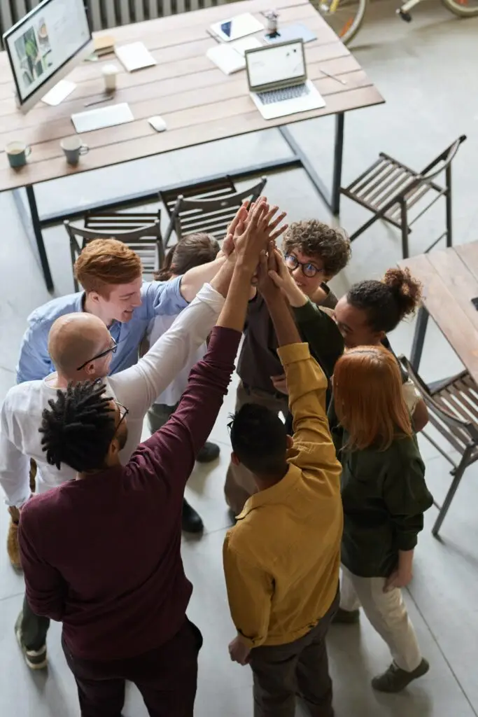 Team of professionals collaborating in a modern office, exemplifying teamwork and the development of a positive workplace culture.