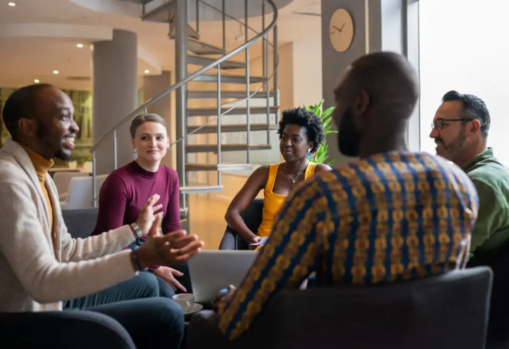 Group of diverse business people having a candid meeting in a modern work space