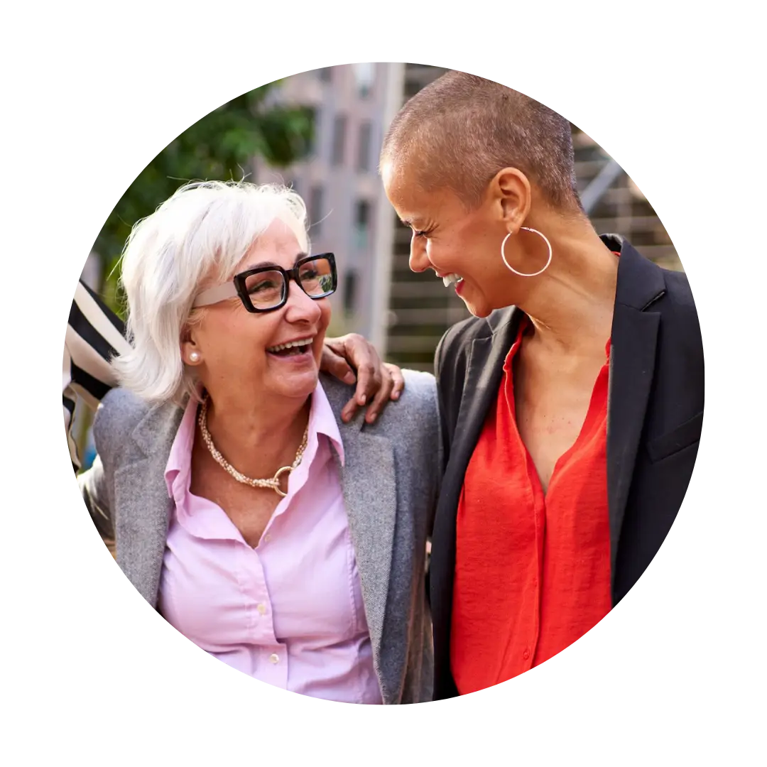 Two women, outside, smiling, walking, joyful