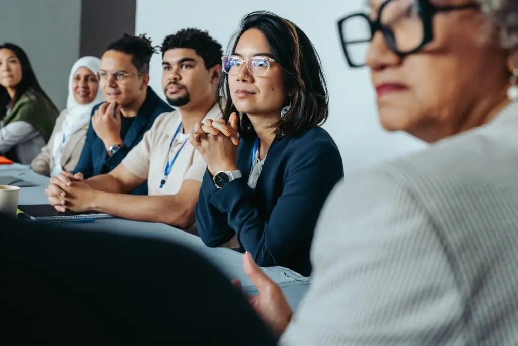 People sitting at table attentive learning.